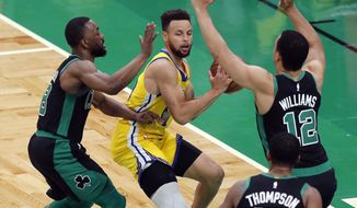 Boston Celtics&#39; Kemba Walker (8) and Grant Williams (12) defend against Golden State Warriors&#39; Stephen Curry, center, during the first half of an NBA basketball game, Saturday, April 17, 2021, in Boston. (AP Photo/Michael Dwyer)