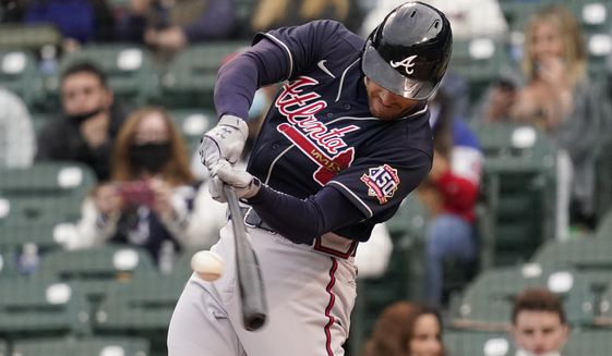 Atlanta Braves Freddie Freeman hits a solo home run against the Chicago Cubs during the first inning of a baseball game in Chicago, Sunday, April 18, 2021. (AP Photo/Nam Y. Huh)