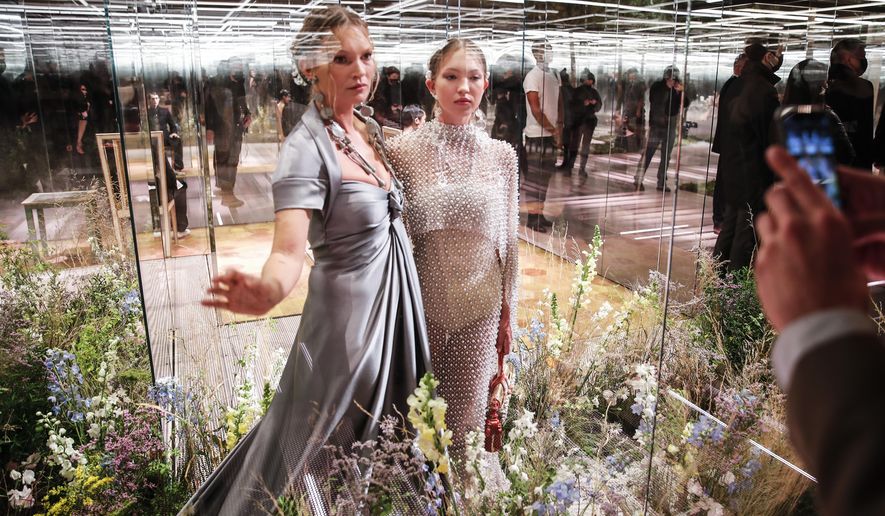 FILE - In this Jan. 27, 2021 file photo, model Kate Moss, left, and her daughter Lila Grace Moss wear a creation for Fendi&#39;s Spring-Summer 2021 Haute Couture fashion collection presented in Paris. The pandemic has torn a multibillion-dollar bite out of the fabric of Europe&#39;s luxury industry, stopped runway shows and forced brands to show their designs digitally instead. Now, amid hopes of a return to near-normality by the year’s end, the industry is asking what fashion will look like as it dusts itself and struggles to its well-heeled feet again.  (AP Photo/Francois Mori, File)