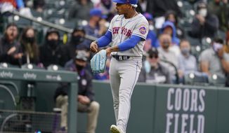 New York Mets starting pitcher Marcus Stroman points to his glove after stopping a ground ball off the bat of Colorado Rockies&#x27; Josh Fuentes in the eighth inning of a baseball game Sunday, April 18, 2021, in Denver. (AP Photo/David Zalubowski)