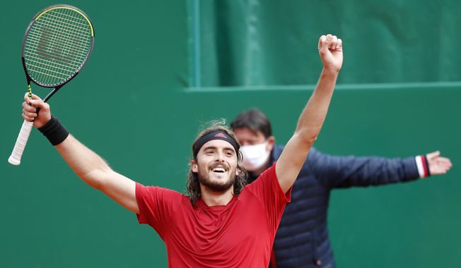 Stefanos Tsitsipas of Greece celebrates after defeating Andrey Rublev of Russia during the Monte Carlo Tennis Masters tournament finals in Monaco, Sunday, April 18, 2021. (AP Photo/Jean-Francois Badias)