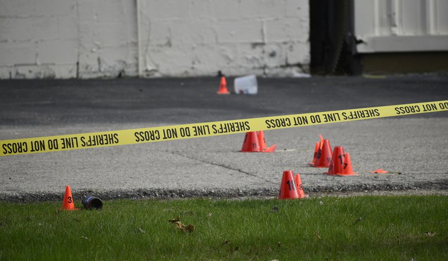 Evidence markers and police tape were in abundance outside the Somers House Tavern and down 15th Place, where shots were fired in a fatal shooting Sunday, April 18, 2021, in Kenosha, Wis. Several people were killed and a few were seriously wounded in a shooting at the busy tavern in southeastern Wisconsin early Sunday, sheriff's officials said. (Deneen Smith/The Kenosha News via AP)