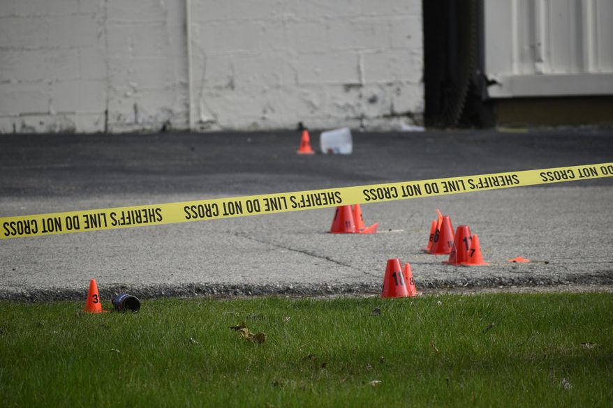 Evidence markers and police tape were in abundance outside the Somers House Tavern and down 15th Place, where shots were fired in a fatal shooting Sunday, April 18, 2021, in Kenosha, Wis. Several people were killed and a few were seriously wounded in a shooting at the busy tavern in southeastern Wisconsin early Sunday, sheriff's officials said. (Deneen Smith/The Kenosha News via AP)