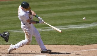 Oakland Athletics&#x27; Sean Murphy hits a solo home run against the Detroit Tigers during the eighth inning of a baseball game in Oakland, Calif., Sunday, April 18, 2021. (AP Photo/Jeff Chiu)