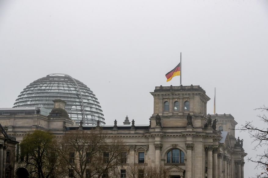 The German flag on top of the Reichstag building is seen at half-mast on the occasion of the central memorial for those who died in the Corona pandemic in Germany, Berlin, April 18, 2021. (Christoph Soeder/dpa via AP)