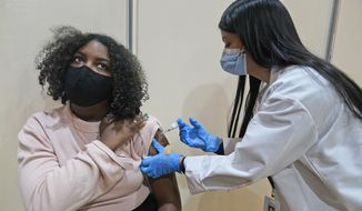 Keidy Ventura, 17, receives her first dose of the Pfizer COVID-19 vaccine in West New York, N.J., Monday, April 19, 2021. Ventura wanted to get the vaccine as soon as possible to protect her multi-generational family that she lives with. New Jersey is opening up COVID-19 vaccine eligibility to those 16 or older beginning today; only the Pfizer vaccine is authorized for teenagers younger than 18. (AP Photo/Seth Wenig)