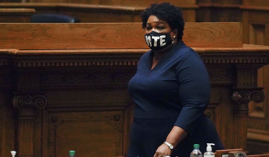 In this Dec. 14, 2020, photo Democrat Stacey Abrams, walks on the Senate floor before members of Georgia&#39;s Electoral College cast their votes at the state Capitol in Atlanta. Abrams, Georgia&#39;s well-known voting rights advocate, is taking a carefully balanced approach in response to new laws many people have said are an attempt to suppress votes of people of color. When asked about the law changes, she is critical but measured. (AP Photo/John Bazemore, Pool) **FILE**