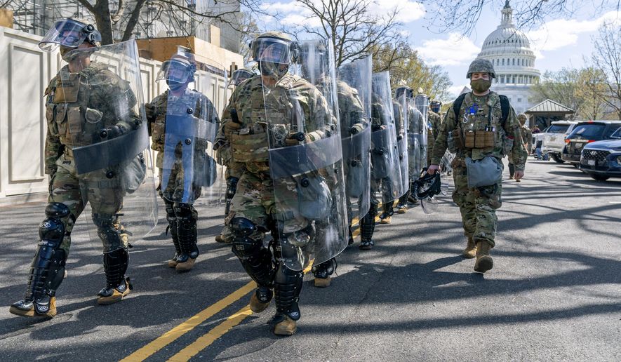 Members of the National Guard leave the Capitol perimeter the they had been guarding, Friday, April 2, 2021, after a car crashed into a barrier on Capitol Hill in Washington. (AP Photo/Jacquelyn Martin)