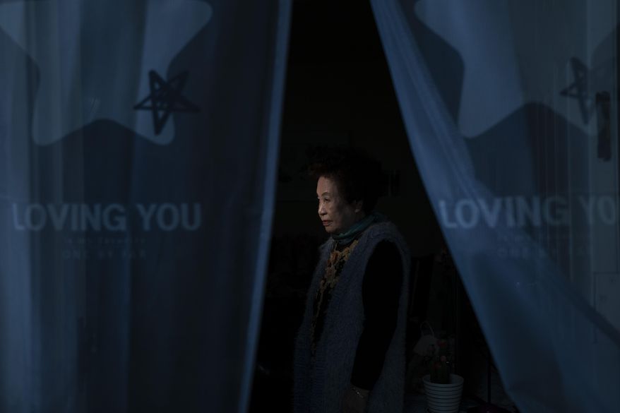 Hea Kyung Kim, an 81-year-old South Korean immigrant, pauses for photos in her apartment in the Koreatown neighborhood of Los Angeles, Wednesday, March 24, 2021. "My children tell me to be careful these days," said Kim. "I have never been a hate crime victim, but it scares me watching the news about it. There is no guarantee it won't happen to me ever." (AP Photo/Jae C. Hong)