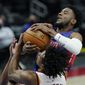 Detroit Pistons guard Josh Jackson and Cleveland Cavaliers guard Collin Sexton battle for control during the second half of an NBA basketball game, Monday, April 19, 2021, in Detroit. (AP Photo/Carlos Osorio)