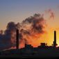 In this July 27, 2018, file photo, the Dave Johnson coal-fired power plant is silhouetted against the morning sun in Glenrock, Wyo. More than 300 businesses and investors are calling on the Biden administration to set an ambitious climate change goal that would cut U.S. greenhouse gas emissions by at least 50% below 2005 levels by 2030. (AP Photo/J. David Ake, File)