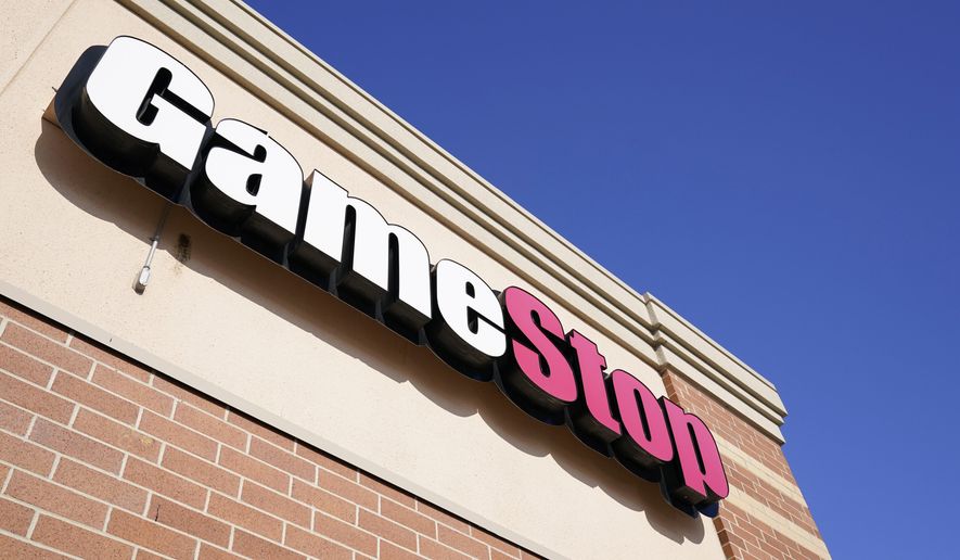 FILE - In this Jan. 28, 2021, file photo, a GameStop sign is seen above a store, in Urbandale, Iowa. Video game retailer GameStop says CEO George Sherman will be stepping down from his post by July 31, 2021. Shares of the Grapevine, Texas-based company rose more than 8% before the market open on Monday, April 19. (AP Photo/Charlie Neibergall, File)