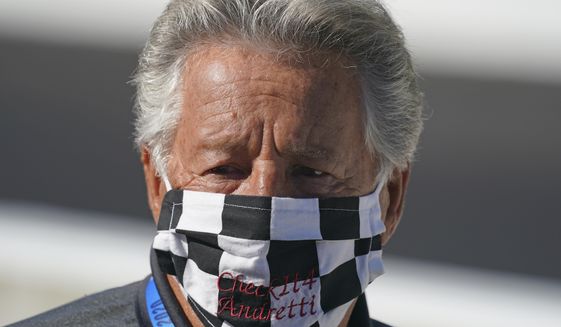 In this Aug. 21, 2020, file photo, Mario Andretti looks on before the final practice session for the Indianapolis 500 auto race at Indianapolis Motor Speedway. Andretti feels the same pain as so many others these days. His wife died two years ago, long before the pandemic. And his beloved nephew lost a brutal battle with colon cancer. But then COVID-19 claimed his twin brother and one of the greatest racers of all time is not immune from the loneliness and depression sweeping the world. (AP Photo/Darron Cummings, File) **FILE**