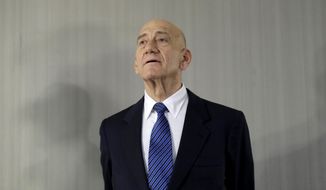 FILE - In this Feb. 11, 2020 file photo, former Israeli Prime Minister Ehud Olmert takes questions from reporters after a news conference in New York. Israeli Prime Minister Benjamin Netanyahu is threatening to sue his predecessor, Olmert, for defamation. Netanyahu is reportedly seeking over $300,000 in damages if Olmert does not apologize for saying the Israeli leader’s family suffers from mental illness. (AP Photo/Seth Wenig, File)