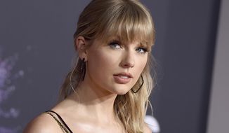 FILE - This Nov. 24, 2019 file photo shows Taylor Swift at the American Music Awards in Los Angeles. Police say a stalker who claims Swift is communicating with him on social media was arrested on a trespassing charge after trying to break into the singer’s Manhattan apartment. A police spokesperson says 52-year-old Hanks Johnson was arrested at 8:30 p.m. Saturday after a 911 caller reported he was inside Swift’s Tribeca building without permission. (Photo by Jordan Strauss/Invision/AP, File)