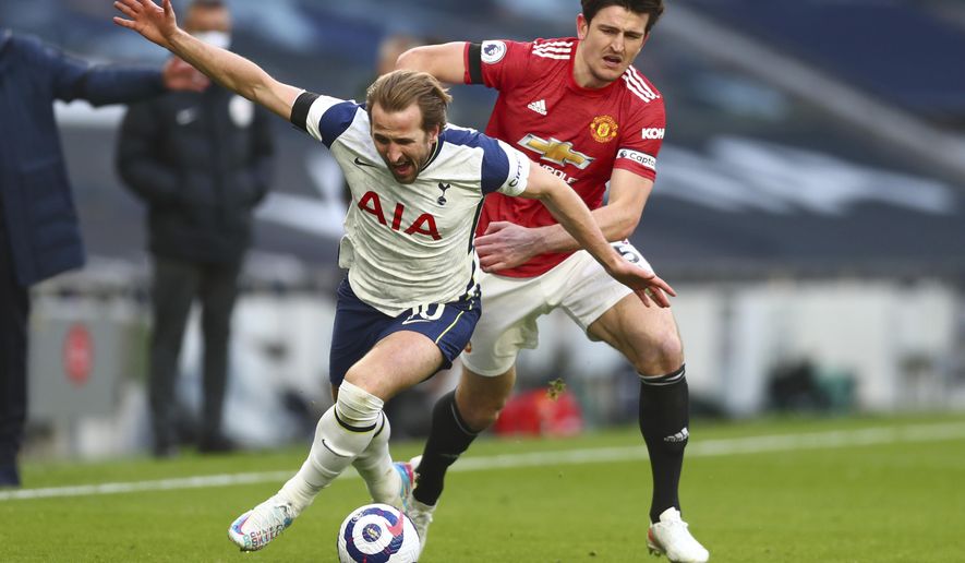 FILE - In this Sunday, April 11, 2021 file photo Tottenham&#39;s Harry Kane, left, is challenged by Manchester United&#39;s Harry Maguire during the English Premier League soccer match between Tottenham Hotspur and Manchester United at the Tottenham Hotspur Stadium in London. UEFA President Aleksander Ceferin says players at the 12 clubs setting up their own Super League could be banned from this year&#39;s European Championship and next year&#39;s World Cup. (Clive Rose/Pool via AP)