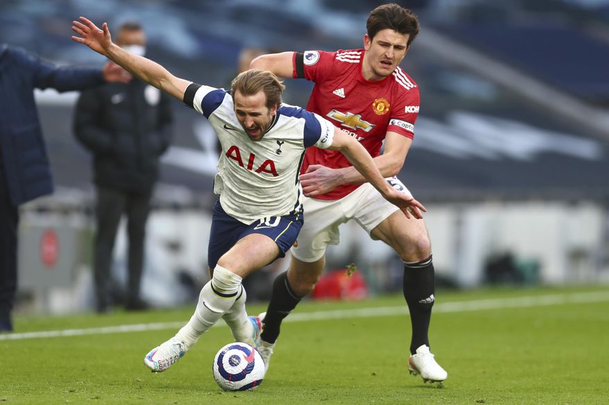 FILE - In this Sunday, April 11, 2021 file photo Tottenham&#39;s Harry Kane, left, is challenged by Manchester United&#39;s Harry Maguire during the English Premier League soccer match between Tottenham Hotspur and Manchester United at the Tottenham Hotspur Stadium in London. UEFA President Aleksander Ceferin says players at the 12 clubs setting up their own Super League could be banned from this year&#39;s European Championship and next year&#39;s World Cup. (Clive Rose/Pool via AP)