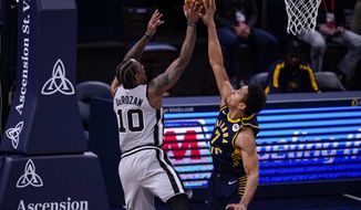 Indiana Pacers guard Malcolm Brogdon, right, blocks the shot of San Antonio Spurs forward DeMar DeRozan, left, during the first half of an NBA basketball game in Indianapolis, Monday, April 19, 2021. (AP Photo/Michael Conroy)