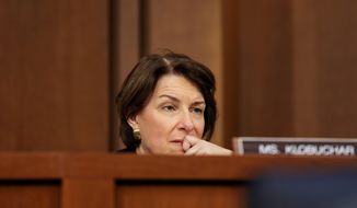 Sens. Mike Lee and Amy Klobuchar wrote to Apple CEO Tim Cook to urge him to attend the antitrust hearing this week. (Associated Press photographs)