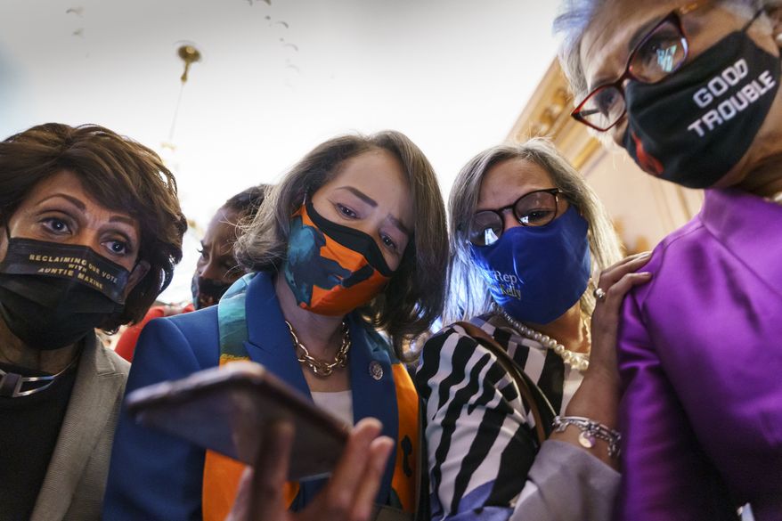 From left, Rep. Maxine Waters, D-Calif., Rep. Lisa Blunt Rochester, D-Del., Rep. Robin Kelly, D-Ill., Rep. Joyce Beatty, D-Ohio, and other members of the Congressional Black Caucus monitor their mobile phones for the verdict in the murder trial of former Minneapolis police Officer Derek Chauvin in the death of George Floyd, on Capitol Hill in Washington, Tuesday, April 20, 2021. (AP Photo/J. Scott Applewhite)