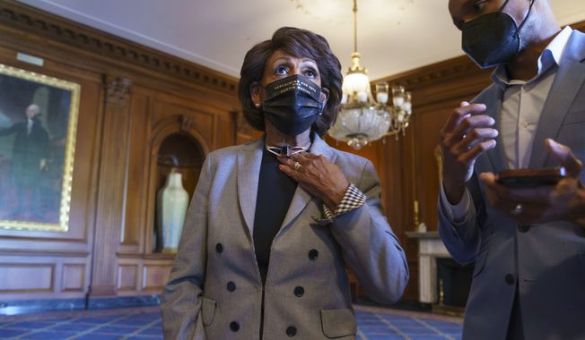 Rep. Maxine Waters, D-Calif., listens to an aide as she joins members of the Congressional Black Caucus to await the verdict in the murder trial of former Minneapolis police Officer Derek Chauvin in the death of George Floyd, on Capitol Hill in Washington, Tuesday, April 20, 2021. (AP Photo/J. Scott Applewhite)