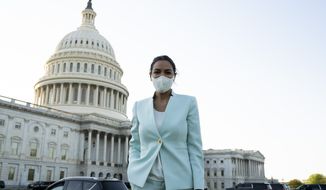 Rep. Alexandria Ocasio-Cortez D-NY, pauses for a photo on her way to an interview on Capitol Hill in Washington, Tuesday, April 20, 2021, after the jury returned guilty verdicts on all three charges in the murder trial of former Minneapolis police Officer Derek Chauvin in the death of George Floyd. (AP Photo/Jose Luis Magana)