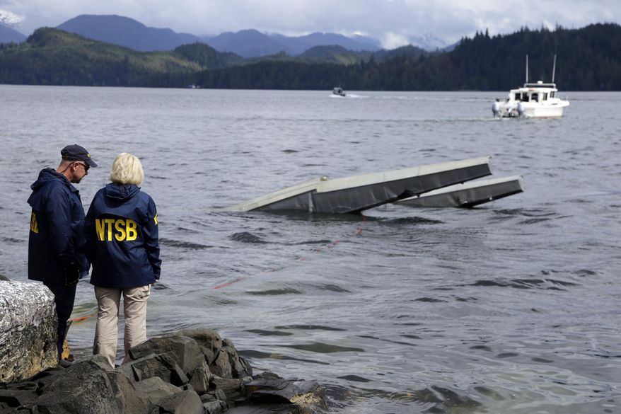 FILE - In this photo provided by the National Transportation Safety Board, NTSB investigator Clint Crookshanks, left, and member Jennifer Homendy stand near the site of some of the wreckage of the DHC-2 Beaver, Wednesday, May 15, 2019, that was involved in a midair collision near Ketchikan, Alaska, a couple of days earlier.  The pilots of two Alaskan sightseeing planes that collided in midair couldn&#x27;t see the other aircraft because airplane structures or a passenger blocked their views, and they didn&#x27;t get electronic alerts about close aircraft because safety systems weren&#x27;t working properly. That&#x27;s what the staff of the National Transportation Safety board found in their investigation. (Peter Knudson/NTSB via AP)