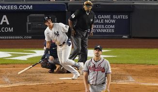 New York Yankees Gio Urshela watches his solo home run as Atlanta Braves starting pitcher Charlie Morton reacts during the fifth inning of an interleague baseball game, Tuesday, April 20, 2021, at Yankee Stadium in New York. Home plate umpire Laz Diaz keeps his eye on the ball. (AP Photo/Kathy Willens)