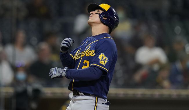 Milwaukee Brewers&#x27; Luis Urias looks skyward after hitting a home run during the third inning of a baseball game against the San Diego Padres, Monday, April 19, 2021, in San Diego. (AP Photo/Gregory Bull)