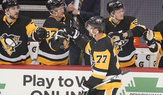 Pittsburgh Penguins&#39; Jeff Carter (77) returns to the bench after scoring during the first period of an NHL hockey game against the New Jersey Devils in Pittsburgh, Tuesday, April 20, 2021. (AP Photo/Gene J. Puskar)