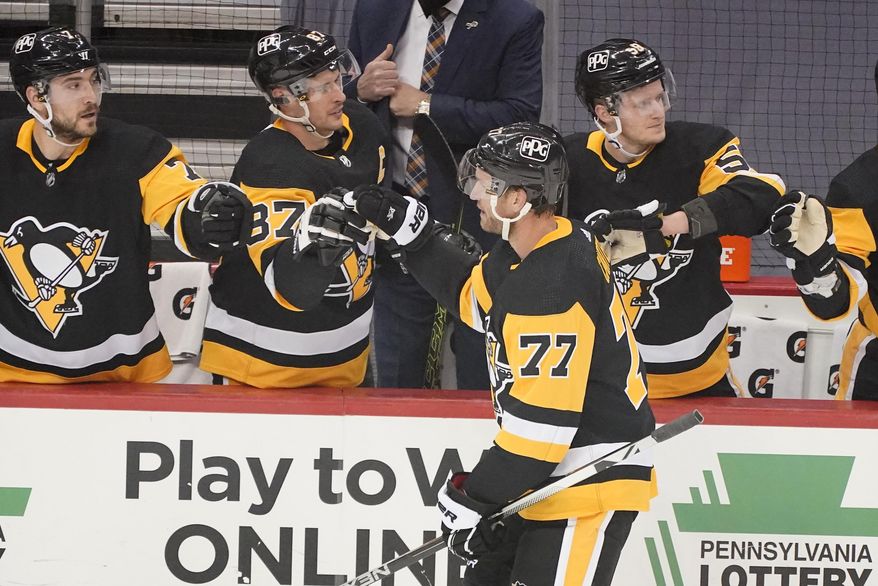 Pittsburgh Penguins&#x27; Jeff Carter (77) returns to the bench after scoring during the first period of an NHL hockey game against the New Jersey Devils in Pittsburgh, Tuesday, April 20, 2021. (AP Photo/Gene J. Puskar)