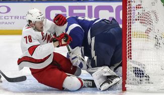 Carolina Hurricanes&#39; Steven Lorentz (78) crashes into Tampa Bay Lightning goaltender Andrei Vasilevskiy during the first period of an NHL hockey game Tuesday, April 20, 2021, in Tampa, Fla. (AP Photo/Mike Carlson)
