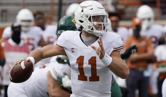 FILE - In this Oct. 24, 2020, file photo, Texas&#39; Sam Ehlinger looks to pass against Baylor during the first half of an NCAA college football game in Austin, Texas. Who would make a college football Super League? Think big-brand schools with large fanbases and a history of success ... such as Texas. (AP Photo/Chuck Burton, File)