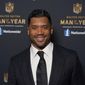 FILE - In this Friday, Feb. 5, 2021 file photo Seattle Seahawks quarterback Russell Wilson poses for a photo at the NFL Honors ceremony as part of Super Bowl 55  in Tampa, Fla. Wilson will return to N.C. State University, where he played football and baseball, this spring as a commencement speaker for the 2021 graduation ceremonies.  (AP Photo/Charlie Riedel, File)