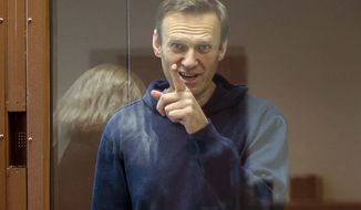 In this Feb. 16, 2021, file photo taken from footage provided by the Babuskinsky District Court, Russian opposition leader Alexei Navalny gestures during a court hearing in Moscow, Russia. Several doctors were prevented Tuesday, April 20, from seeing Navalny in a prison hospital after his three-week hunger strike, and prosecutors also detailed a sweeping, new case against his organization. (Babuskinsky District Court Press Service via AP, File)