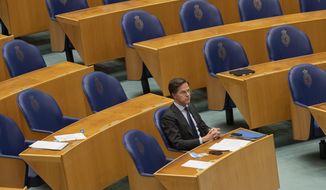 FILE - In this file photo dated  Thursday, April 1, 2021, Dutch caretaker Prime Minister Mark Rutte listens to a debate in parliament in The Hague, Netherlands. Rutte announced a significant easing in his country&#39;s months-long coronavirus lockdown Tuesday April 20, 2021, calling it a delicate balancing act as infections remain stubbornly high, and as lockdown fatigue grows.(AP Photo/Peter Dejong)