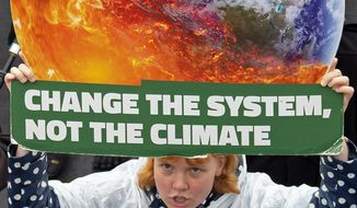 A demonstrator holds a poster as she attends a protest climate strike and rally of the &quot;Friday For Future Movement&quot; on Sept. 27, 2019. (Associated Press)