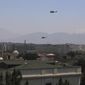 U.S. Black Hawk military helicopters fly over the city of Kabul, Afghanistan, Monday, April 19, 2021. (AP Photo/Rahmat Gul)