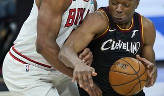 Cleveland Cavaliers&#39; Mfiondu Kabengele, right, drives past Chicago Bulls&#39; Cristiano Felicio during the second half of an NBA basketball game, Wednesday, April 21, 2021, in Cleveland. (AP Photo/Tony Dejak)