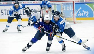 FILE - Kendall Coyne Schofield, left, of the United States and Nelli Laitinen of Finland vie for the puck during the IIHF Women&#39;s Ice Hockey World Championships final match between the United States and Finland in Espoo, Finland, in this Sunday, April 14, 2019, file photo. The International Ice Hockey Federation is scrambling to reschedule the women’s world hockey championships after health officials in Nova Scotia, Canada, on Wednesday, April 21, 2021, scrapped holding the tournament next month due to COVID-19 concerns. IIHF chief Rene Fasel told The Associated Press by phone he was blind-sided by the decision, which was made at essentially the last minute. (Mikko Stig/Lehtikuva via AP, File)