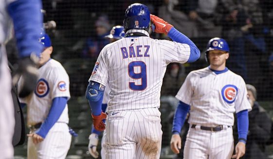 Chicago Cubs Javier Baez (9) celebrates his grand slam home run against the New York Mets during the sixth inning of a baseball game Wednesday, April 21, 2021, in Chicago. (AP Photo/Mark Black)