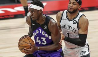 Toronto Raptors&#39; Pascal Siakam, left, is defended by Brooklyn Nets&#39; Bruce Brown during the second half of an NBA basketball game Wednesday, April 21, 2021, in Tampa, Fla. The Raptors won 114-103. (AP Photo/Mike Carlson)