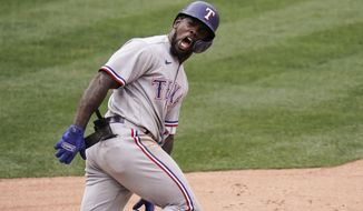 Texas Rangers&#x27; Adolis Garcia celebrates his three-run home run during the eighth inning of a baseball game against the Los Angeles Angels, Wednesday, April 21, 2021, in Anaheim, Calif. (AP Photo/Jae C. Hong)