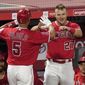 Los Angeles Angels&#39; Albert Pujols, left, is congratulate by Mike Trout after hitting a solo home run during the seventh inning of a baseball game against the Texas Rangers Tuesday, April 20, 2021, in Anaheim, Calif. (AP Photo/Mark J. Terrill)