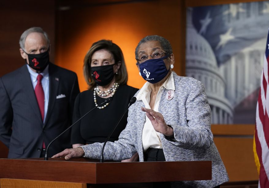 In this April 21, 2021, file photo, Del. Eleanor Holmes-Norton, D-D.C., center, joined from left by Sen. Tom Carper, D-Del., and House Speaker Nancy Pelosi, D-Calif., speaks at a news conference ahead of the House vote on H.R. 51- the Washington, D.C. Admission Act, on Capitol Hill in Washington (AP Photo/J. Scott Applewhite) ** FILE **