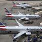 FILE - In this July 17, 2019 file photo American Airlines planes are parked on the tarmac at Phoenix Sky Harbor International Airport in Phoenix. American Airlines Group Inc. (AAL) on Thursday, April 22, 2021, reported a loss of $1.25 billion in its first quarter. (AP Photo/Ross D. Franklin, File)