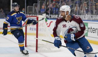 Colorado Avalanche&#39;s Pierre-Edouard Bellemare (41) looks back at he teammates after scoring an empty-net goal as St. Louis Blues&#39; Torey Krug (47) skates in the background during the third period of an NHL hockey game Thursday, April 22, 2021, in St. Louis. (AP Photo/Jeff Roberson)