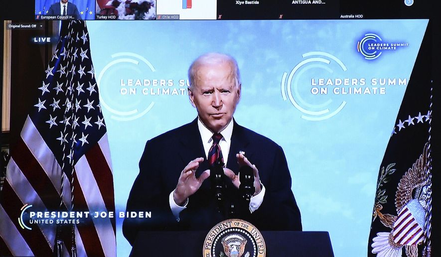 U.S. President Joe Biden is seen on a screen as European Council President Charles Michel attends a virtual Global Climate Summit via video link from the European Council building in Brussels, Thursday, April 22, 2021. (Johanna Geron, Pool via AP)