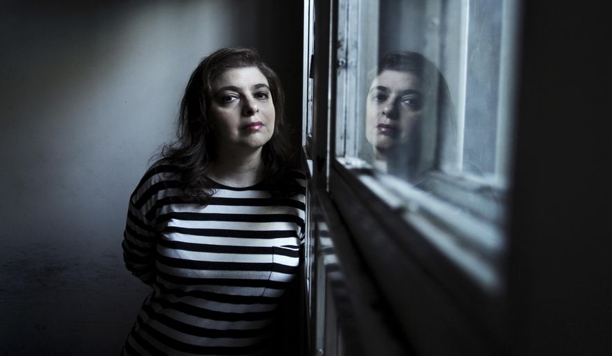 FILE - In this Friday, April 22, 2016 file photo, Argentine writer Mariana Enriquez poses for a portrait in Buenos Aires, Argentina. Books from Europe and Latin America that blur the boundaries of fiction, history and memoir are the final six contenders for the 50,000 pound ($69,000) International Booker Prize. On the shortlist is imaginative short-story collection “The Dangers of Smoking in Bed” by Argentina’s Mariana Enriquez. (AP Photo/Leandro Teysseire, File)
