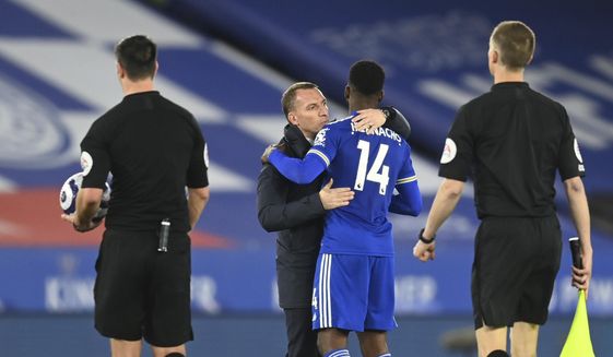 Leicester&#39;s manager Brendan Rodgers, second left, celebrates with Leicester&#39;s Kelechi Iheanacho at the end of the English Premier League soccer match between Leicester City and West Bromwich Albion at the King Power Stadium in Leicester, England, Thursday, April 22, 2021. (Michael Regan/Pool via AP)